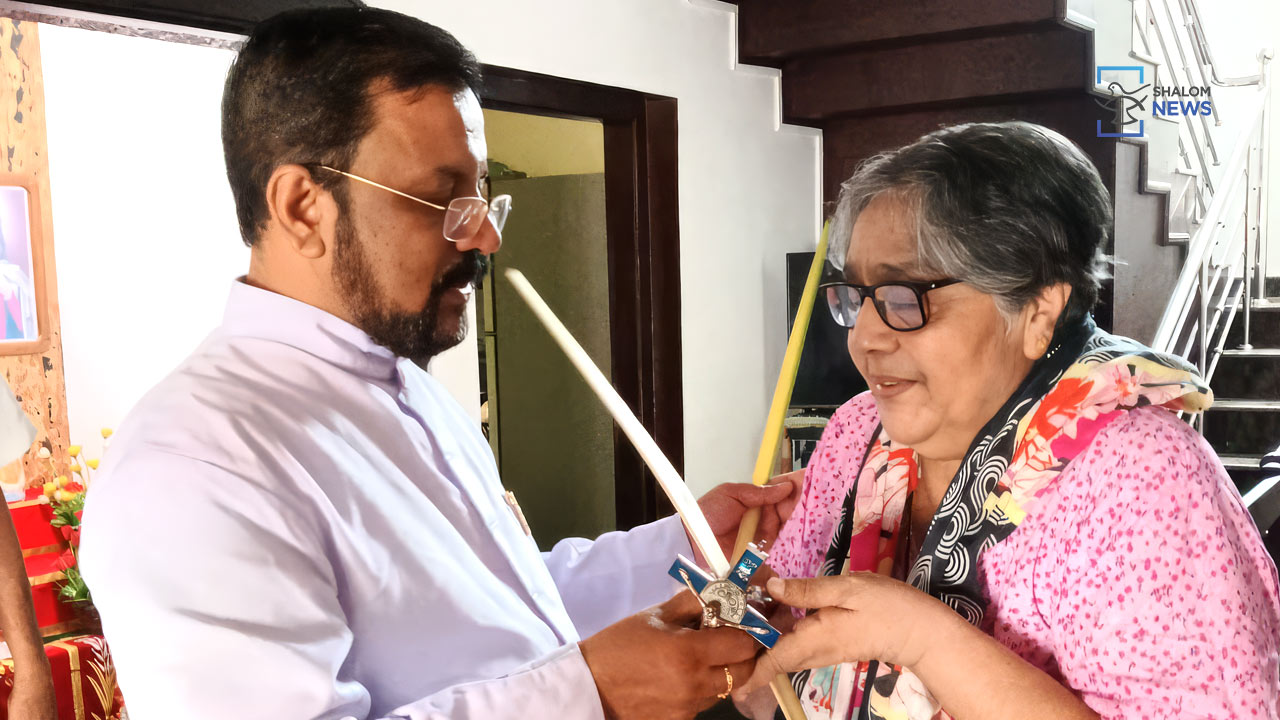 priest distributes palm leaves home emotional faithful Holy Week
