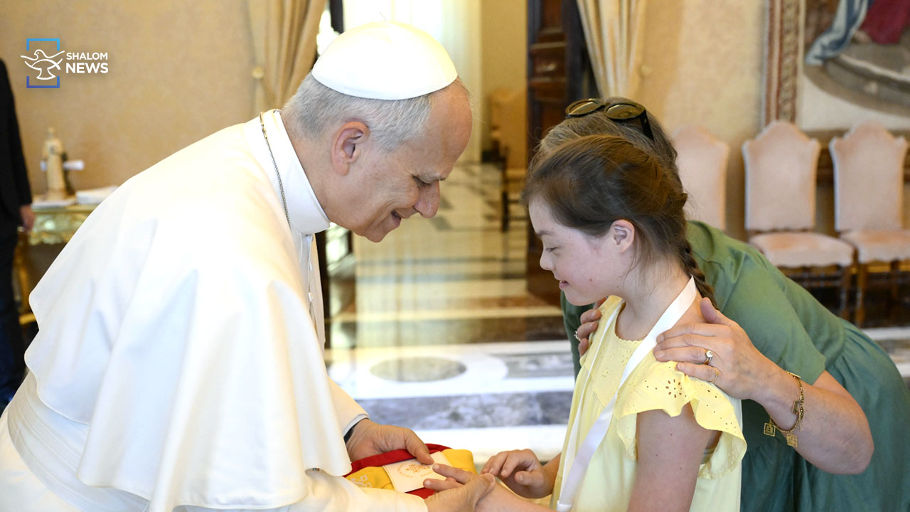 Pope embraces people with Down syndrome